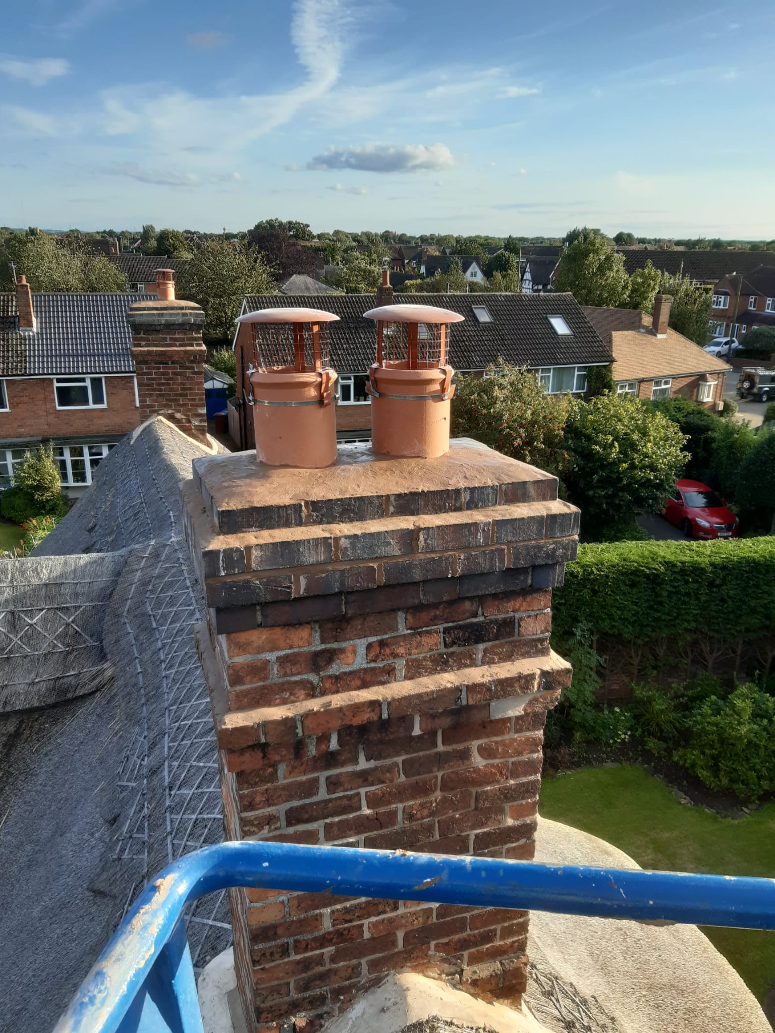 Repaired chimney pots on thatched roof